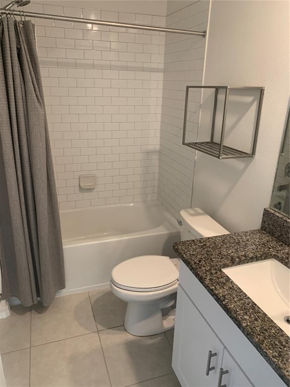 6930 Ripple Pond Loop Zephyrhills, FL 33541 - Photo 27 of 29 a bathroom with a granite countertop sink toilet and shower