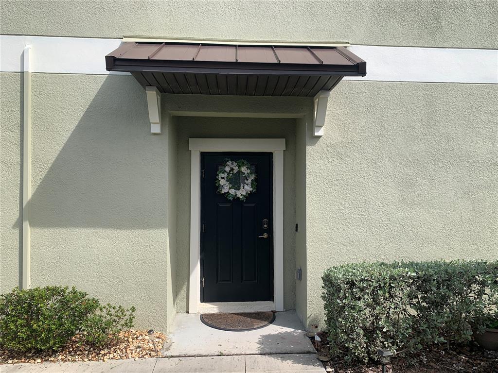6930 Ripple Pond Loop Zephyrhills, FL 33541 - Photo 3 of 29 a view of wooden door