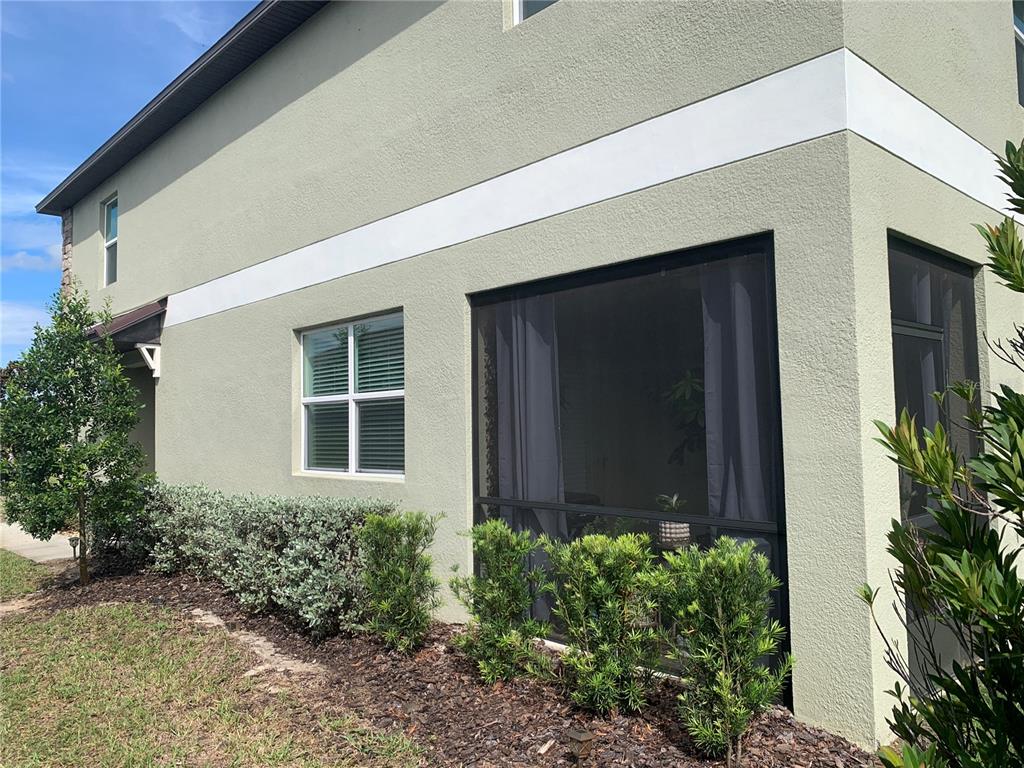 6930 Ripple Pond Loop Zephyrhills, FL 33541 - Photo 4 of 29 a front view of a house with garden