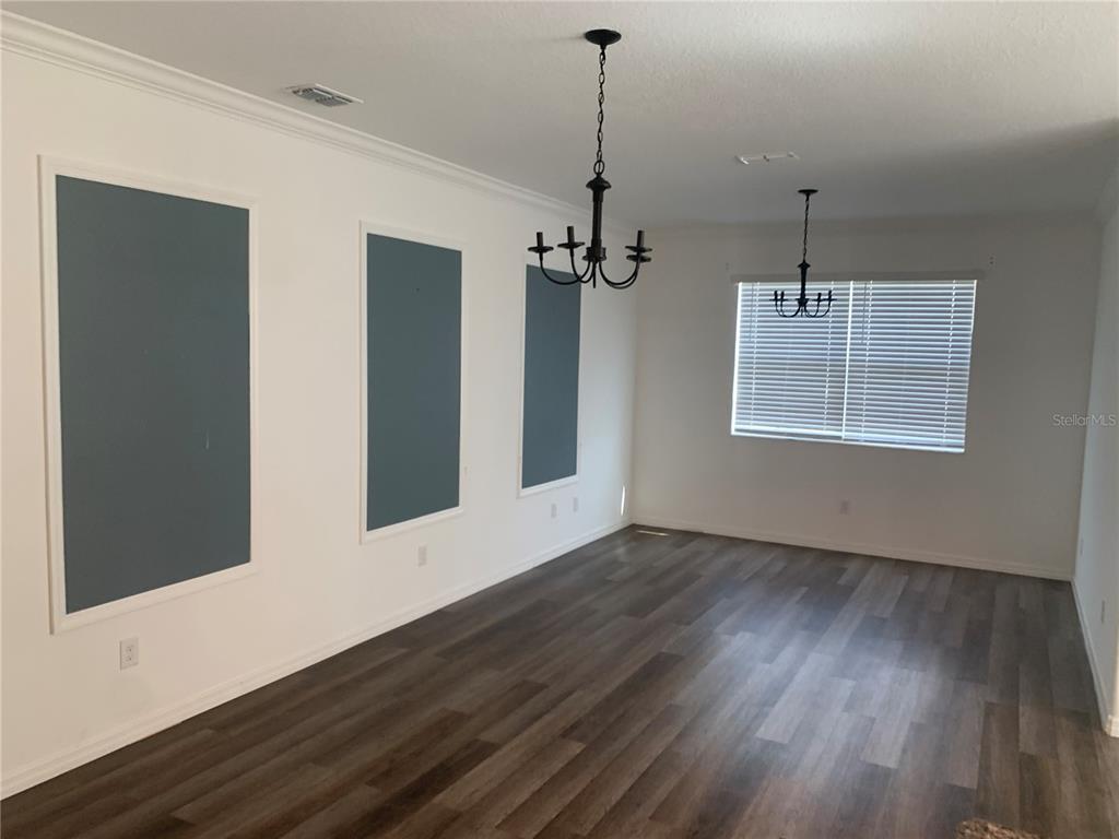 6930 Ripple Pond Loop Zephyrhills, FL 33541 - Photo 8 of 29 a view of an empty room with wooden floor and a window