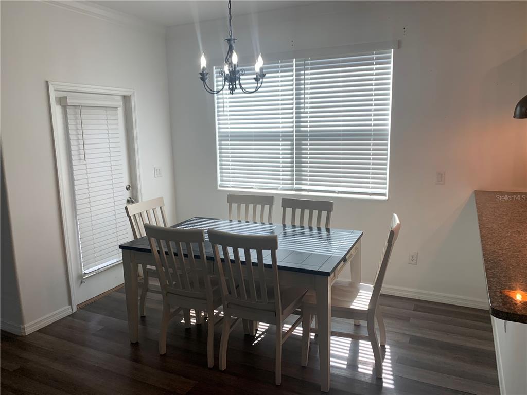 6930 Ripple Pond Loop Zephyrhills, FL 33541 - Photo 9 of 29 a view of a dining room with furniture and wooden floor