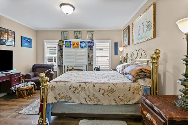 a bedroom with a bed and wooden floor