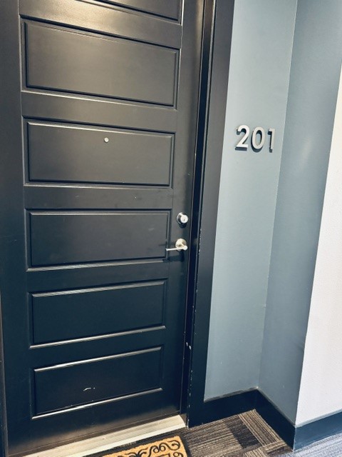 6444 Burnet Road, Unit 201 Austin, TX 78757 - Photo 2 of 18 Enter through a sleek panel door, marking the threshold of this contemporary space.