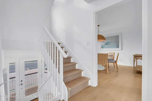 a view of an empty room with a fireplace and a window