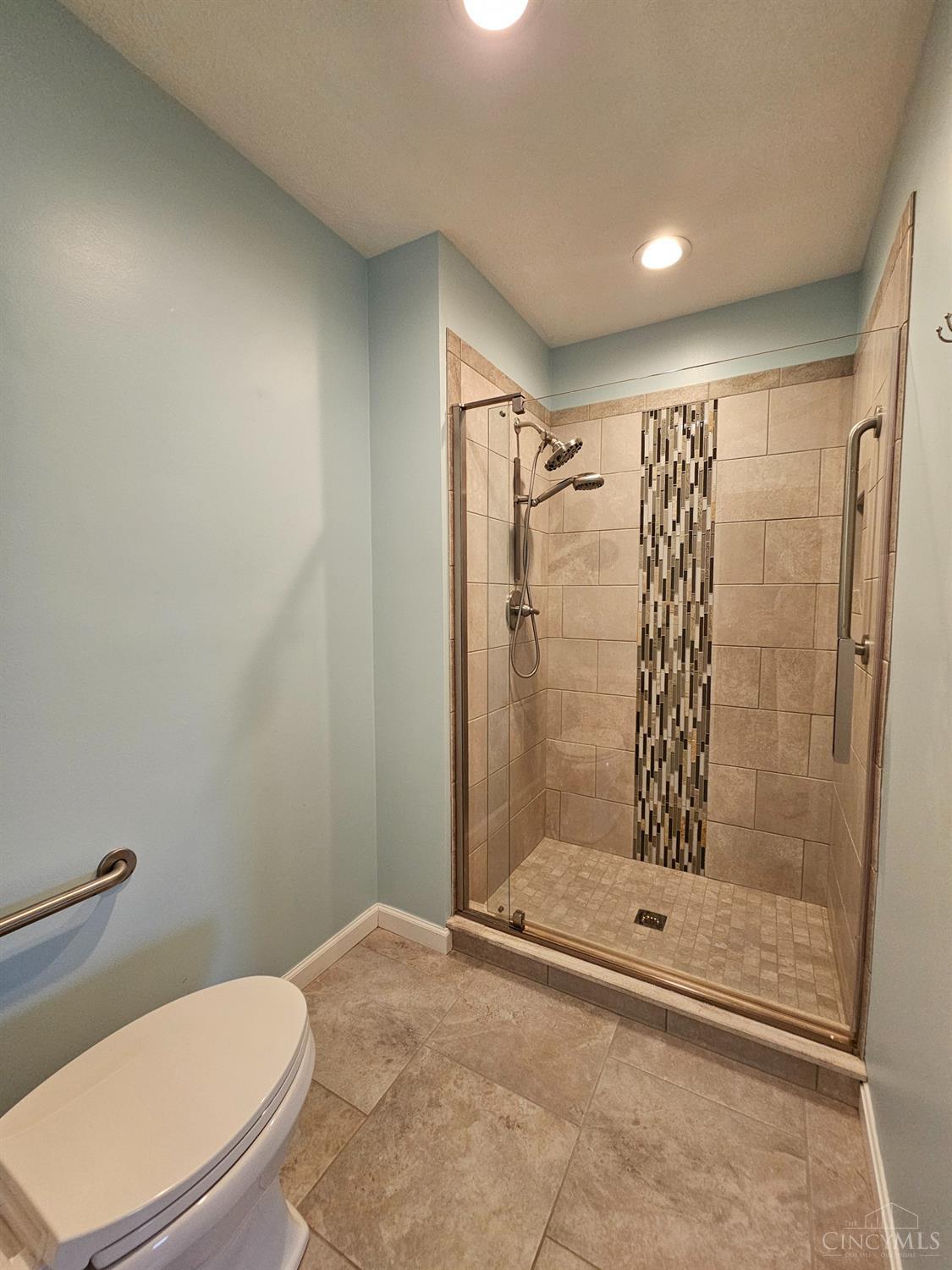 4331 Regency Ridge Court, Unit 306 Cincinnati, OH 45248 - Photo 23 of 45 Walk-in tiled shower with grab bar. Comfort height toilet with grab bar.