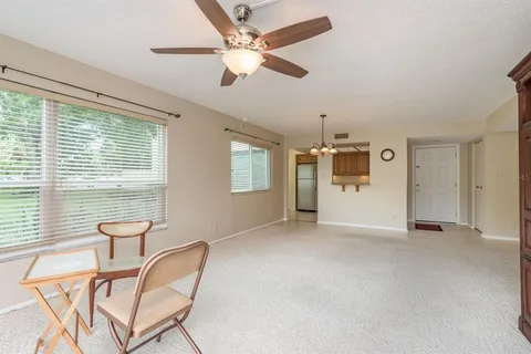 a room with a dresser and chandelier