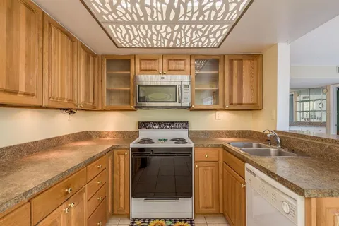 a view of kitchen with a refrigerator cabinets and a dishwasher