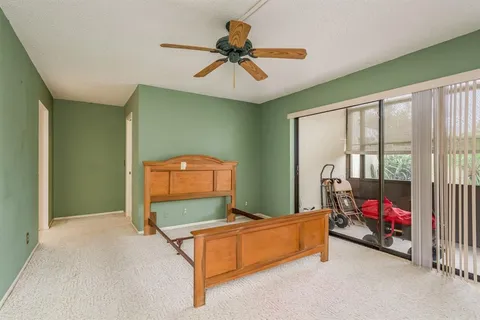 a room with pool table and windows