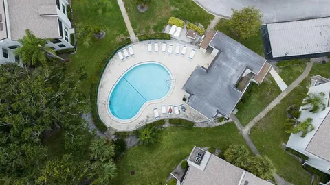 an aerial view of house with swimming pool and outdoor space