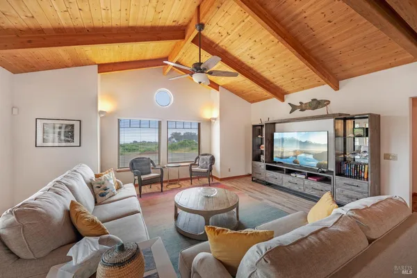 a living room with furniture a large window and a flat screen tv