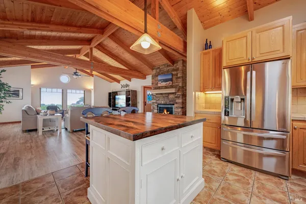 a kitchen with stainless steel appliances granite countertop a stove a refrigerator and a refrigerator