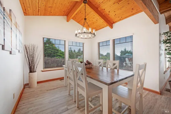 a view of a dining room with furniture wooden floor and a chandelier