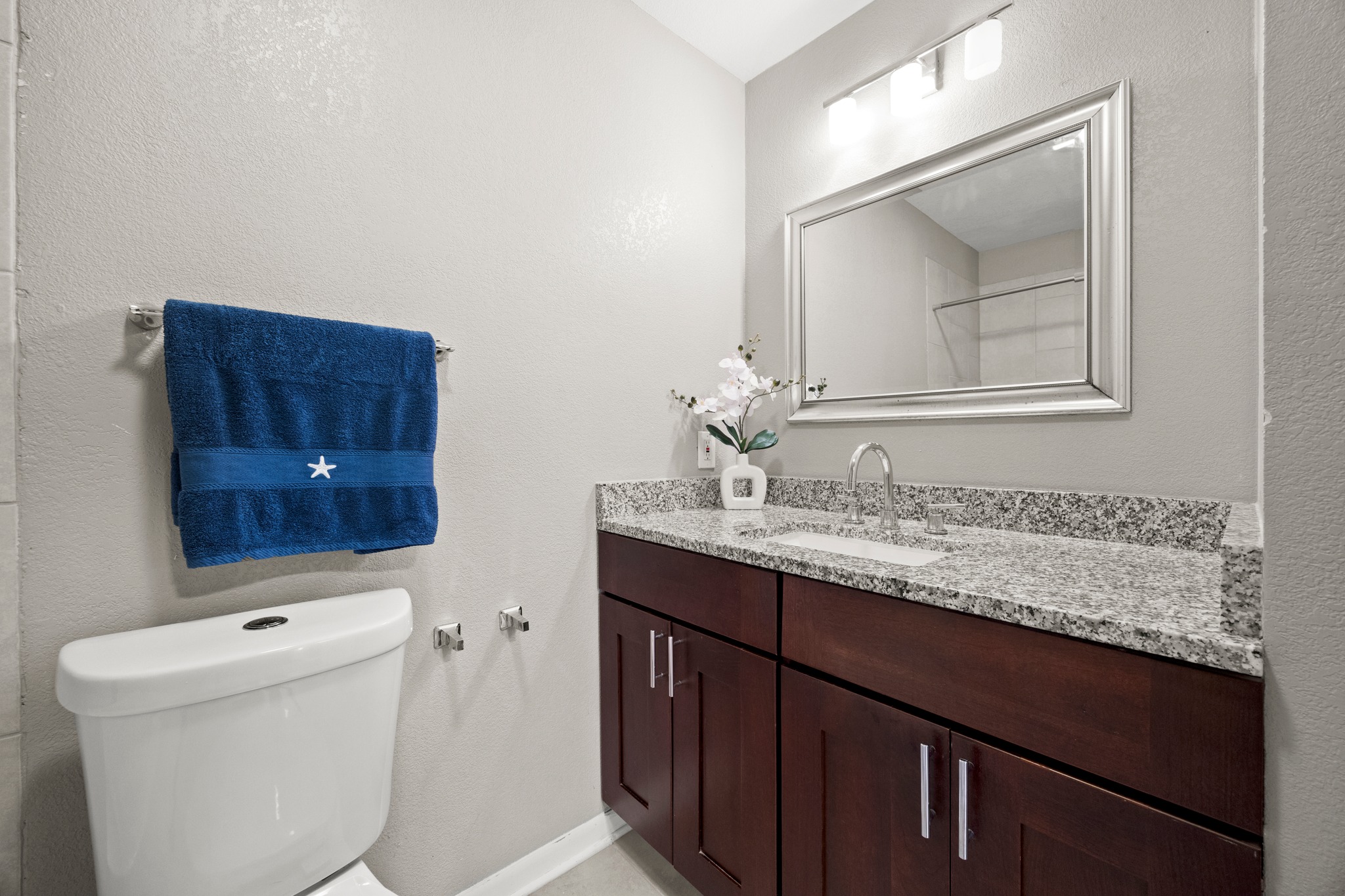 8330 Fathom Circle, Unit 501 Austin, TX 78750 - Photo 12 of 26 a bathroom with a granite countertop sink and a mirror