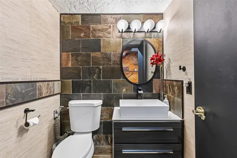 a bathroom with a toilet a sink and a mirror