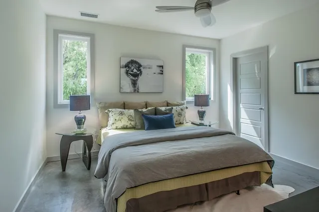 a bedroom with a bed and a window