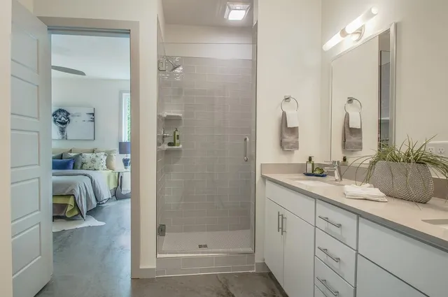 a spacious bathroom with a granite countertop sink a toilet and shower