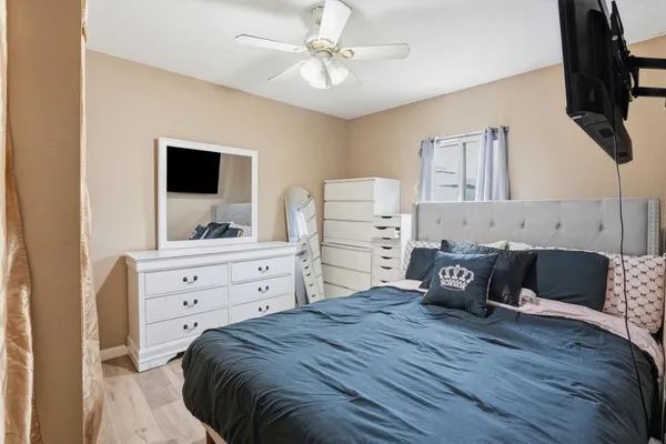 a bedroom with a bed and a flat screen tv