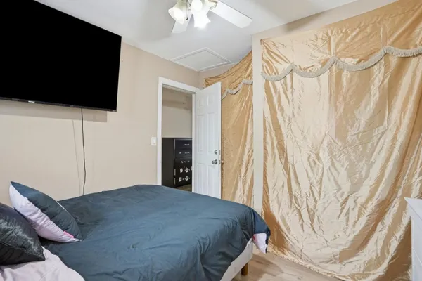 a bedroom with a bed and a flat screen tv