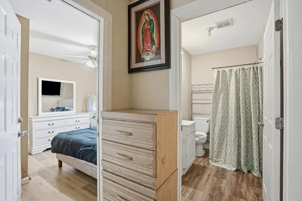 a bedroom with a bed and a view of walk in closet