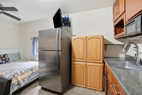 a kitchen with stainless steel appliances granite countertop a refrigerator and a sink