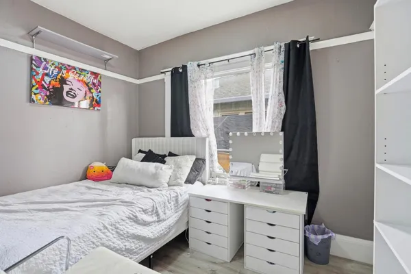 a bedroom with a bed and a dresser in it