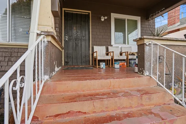 a backyard of a house with table and chairs