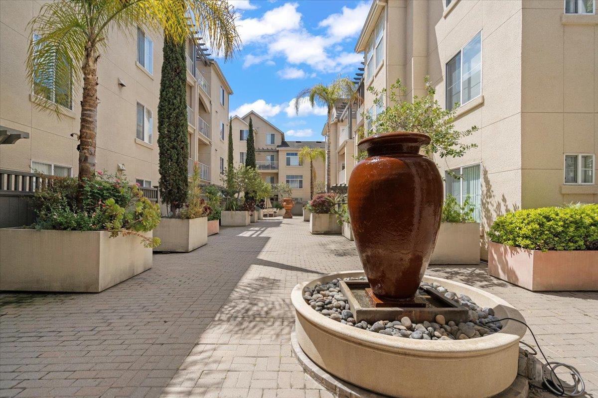 a view of a fountain in the patio with a potted plant