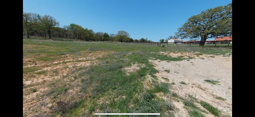 1031 Akin Road Poolville, TX 76487 - Photo 4 of 9 a view of a lake with a yard