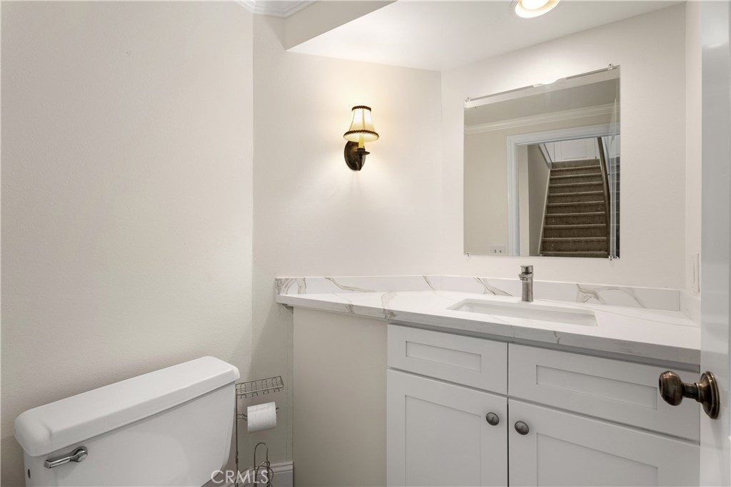 3 Kamalii Court, Unit 276 Newport Beach, CA 92663 - Photo 14 of 28 a bathroom with a toilet sink and mirror