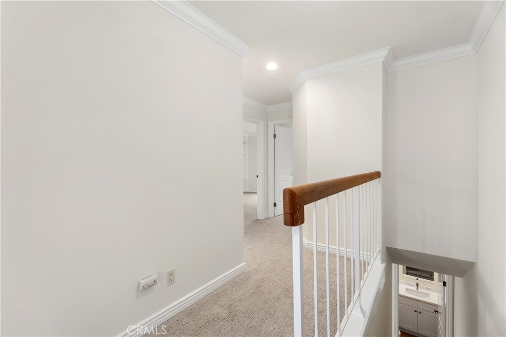 3 Kamalii Court, Unit 276 Newport Beach, CA 92663 - Photo 16 of 28 a view of a bedroom with a white wall and wooden floor