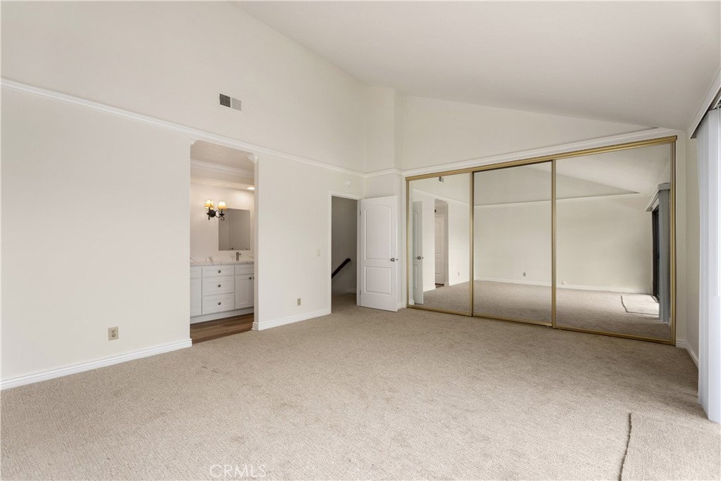 3 Kamalii Court, Unit 276 Newport Beach, CA 92663 - Photo 24 of 28 an empty room with a cabinet and mirrors