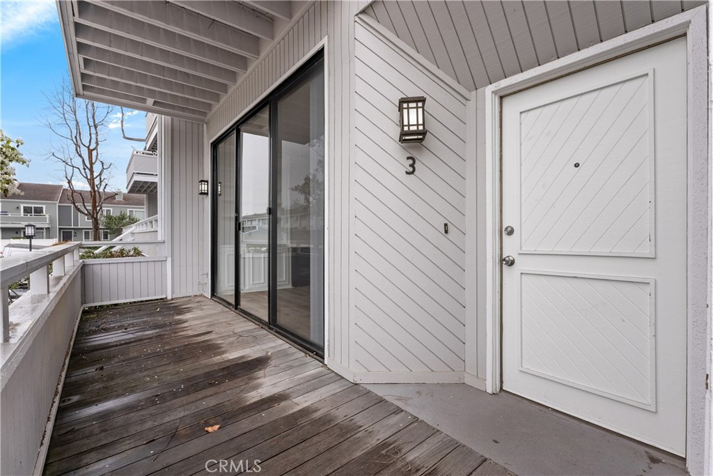 3 Kamalii Court, Unit 276 Newport Beach, CA 92663 - Photo 3 of 28 a view of a porch with wooden floor and brick walls