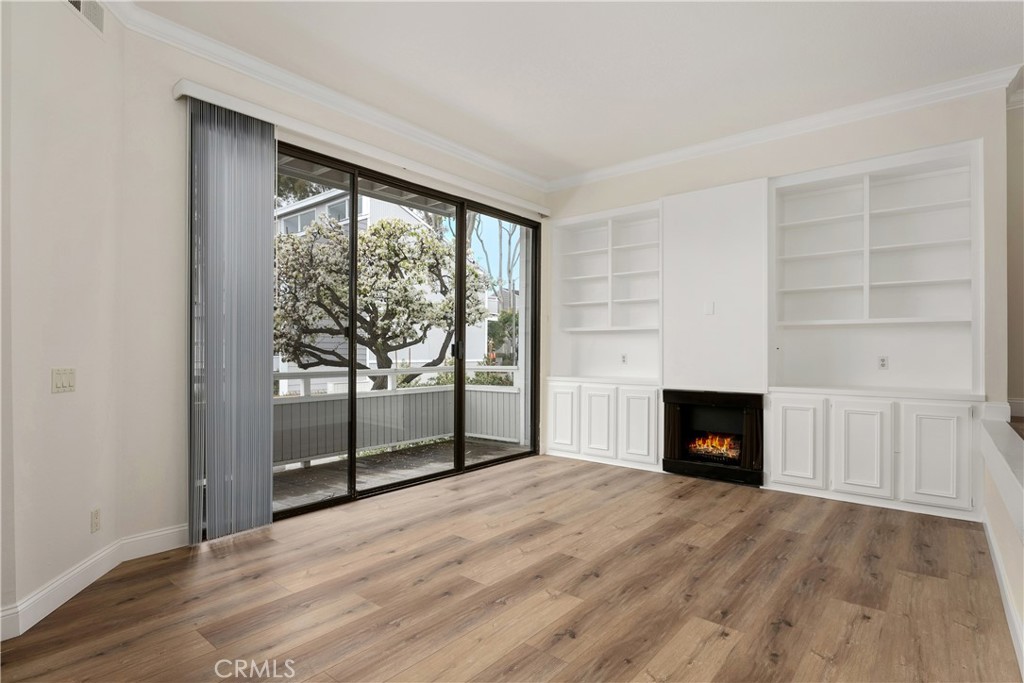 3 Kamalii Court, Unit 276 Newport Beach, CA 92663 - Photo 6 of 28 an empty room with windows and fireplace