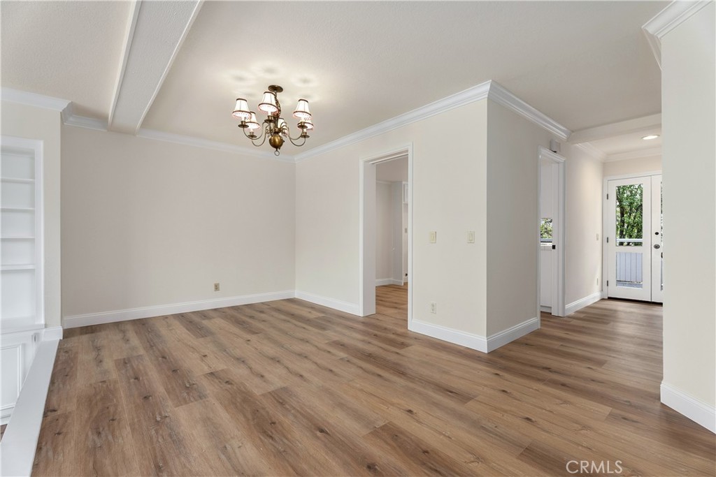 3 Kamalii Court, Unit 276 Newport Beach, CA 92663 - Photo 8 of 28 wooden floor in an empty room with a window