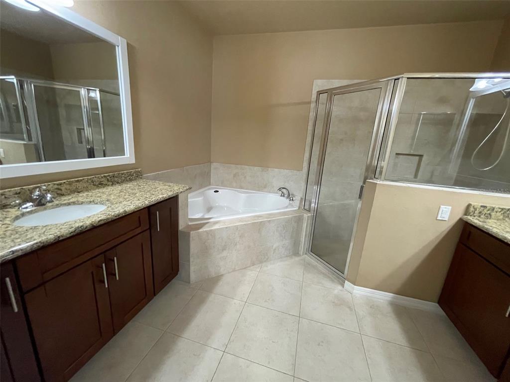 7879 Southwest 80th Drive Gainesville, FL 32608 - Photo 11 of 23 a bathroom with a sink a toilet and shower