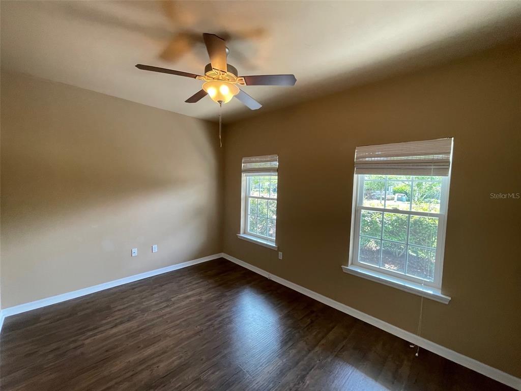 7879 Southwest 80th Drive Gainesville, FL 32608 - Photo 14 of 23 a view of an empty room with wooden floor and a window