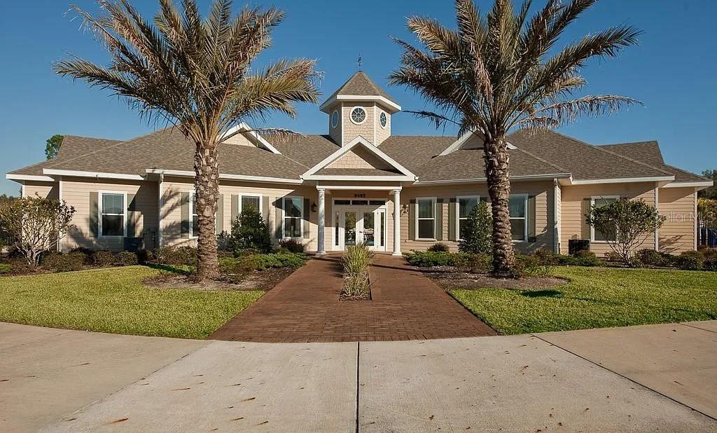 7879 Southwest 80th Drive Gainesville, FL 32608 - Photo 22 of 23 a front view of a house with a garden