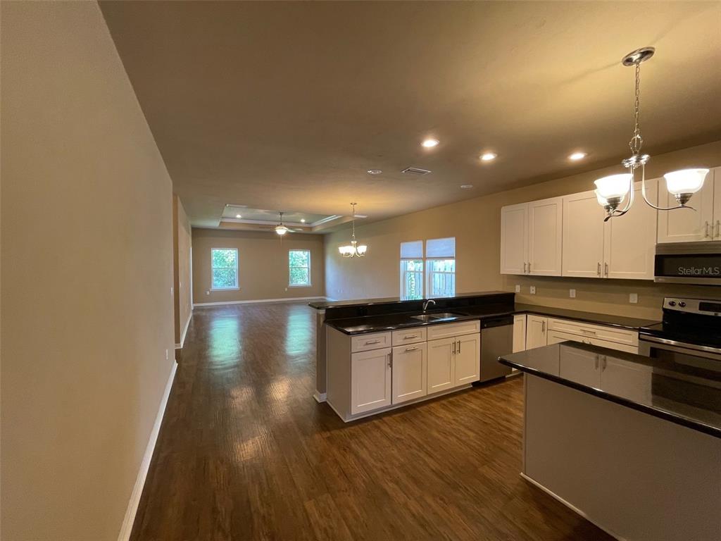 7879 Southwest 80th Drive Gainesville, FL 32608 - Photo 4 of 23 a kitchen with stainless steel appliances granite countertop a stove a sink and a refrigerator