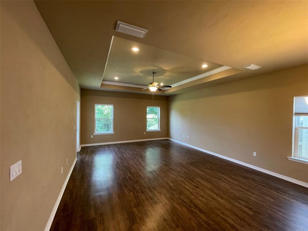 7879 Southwest 80th Drive Gainesville, FL 32608 - Photo 5 of 23 a view of empty room with wooden floor and fan