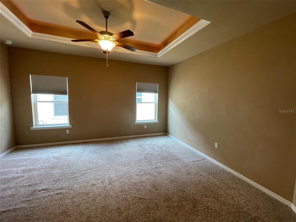 7879 Southwest 80th Drive Gainesville, FL 32608 - Photo 10 of 23 an empty room with a ceiling fan and window