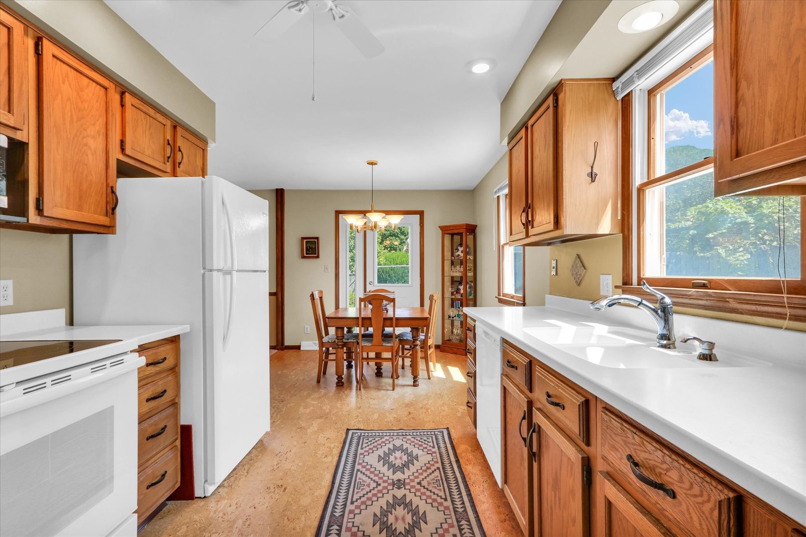 1506 Harrington Drive Champaign, IL 61821 - Photo 15 of 37 a kitchen with granite countertop a refrigerator a sink dishwasher a dining table and chairs with wooden floor