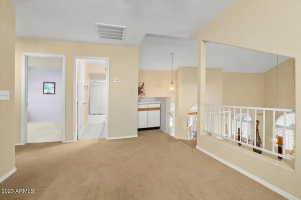 a view of a hallway with wooden shelves