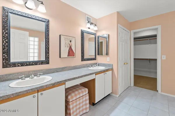 a bathroom with a sink double vanity and a mirror