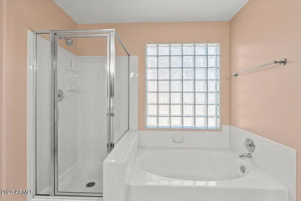 a bathroom with a bathtub and shower