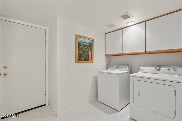 a view of storage and utility room with washer and dryer