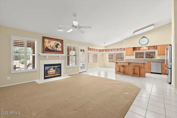 a large white room with a fireplace and cabinets