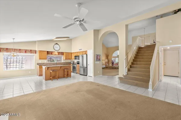 a view of a kitchen with furniture and staircase