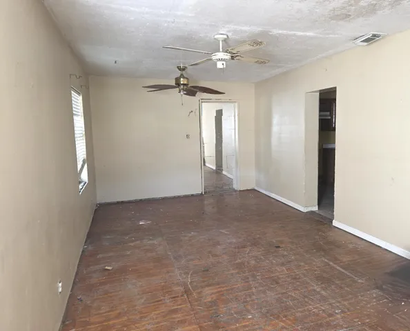 a view of a room with a ceiling fan