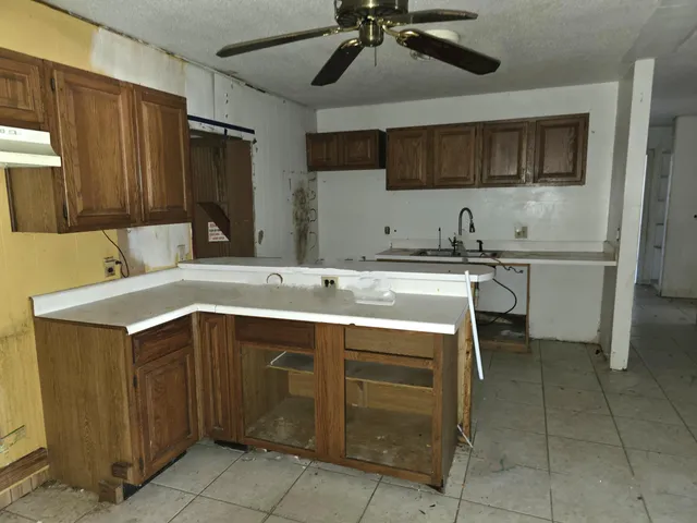 a kitchen with granite countertop sink cabinets and stainless steel appliances