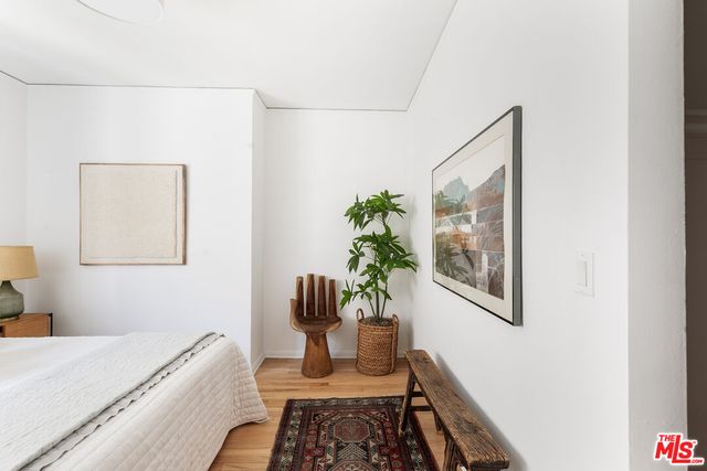 a room with a bed and a potted plant